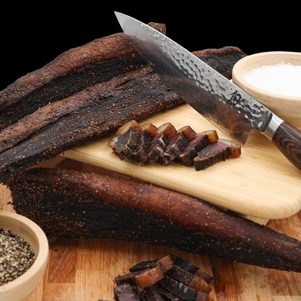 Pile of traditional sliced beef biltong seasoned with coriander and spices at The Village Butcher, Hauraki.